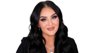 "Professional portrait of beauty influencer Mikayla Nogueira in a brightly lit makeup studio, featuring her signature glamorous makeup look and a confident smile, suitable for a blog post about her net worth and career."